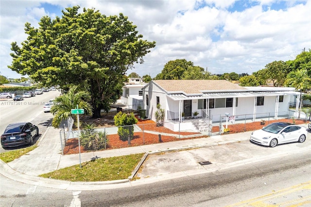1710 E 6th Ave, Hialeah, FL 33010 - view of front facade with covered porch and a fenced front yard