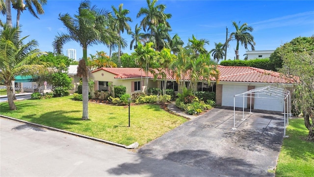 view of front of house featuring concrete driveway, a tile roof, stucco siding, a front lawn, and a garage