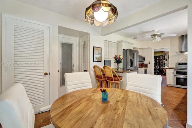 dining space with light tile patterned floors and a ceiling fan
