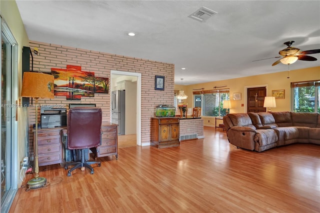 interior space featuring light wood-style flooring, visible vents, brick wall, recessed lighting, and a ceiling fan