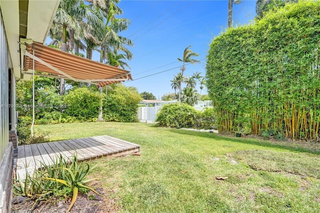 view of yard featuring fence and a wooden deck