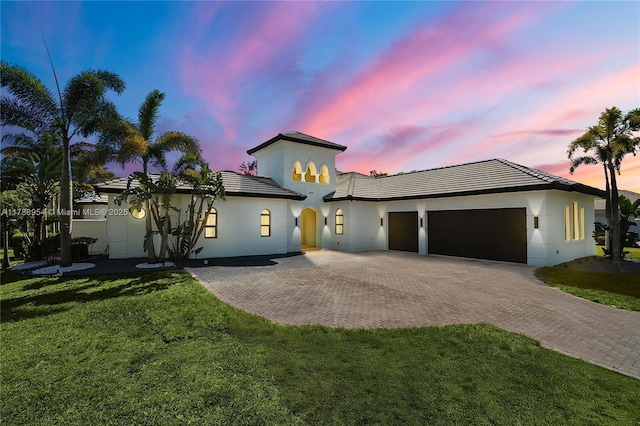 499 SW Squire Johns Ln, Palm City, FL 34990 - view of front of house with an attached garage, decorative driveway, a front lawn, and stucco siding
