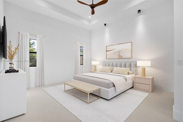 499 SW Squire Johns Ln, Palm City, FL 34990 - bedroom featuring recessed lighting, concrete floors, a ceiling fan, and a tray ceiling
