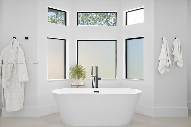 499 SW Squire Johns Ln, Palm City, FL 34990 - full bathroom with a soaking tub and a high ceiling