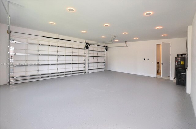 499 SW Squire Johns Ln, Palm City, FL 34990 - garage featuring recessed lighting and water heater