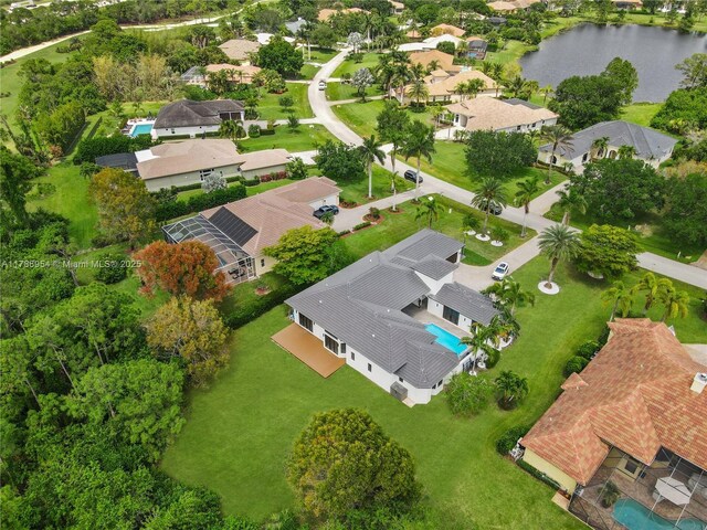 499 SW Squire Johns Ln, Palm City, FL 34990 - back of house featuring stucco siding, an outdoor pool, a patio area, and driveway
