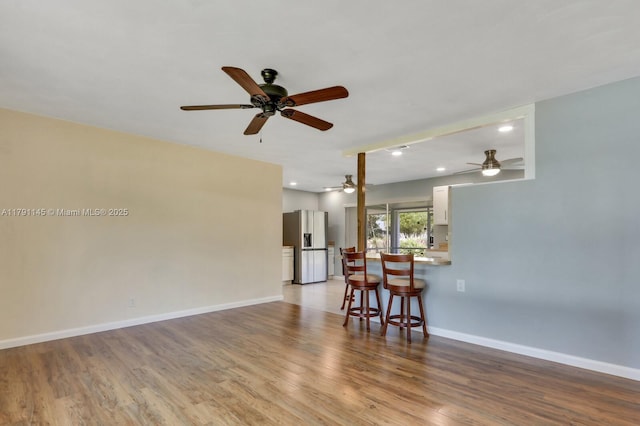 interior space with recessed lighting, baseboards, ceiling fan, and wood finished floors