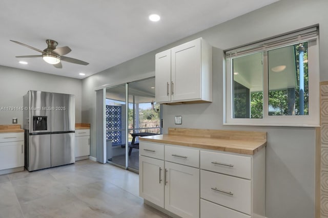kitchen featuring a ceiling fan, wood counters, white cabinets, and stainless steel fridge with ice dispenser