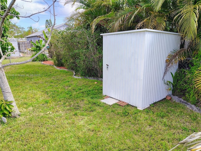 view of yard with an outdoor structure and a shed