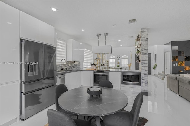 dining area featuring a healthy amount of sunlight, recessed lighting, and visible vents