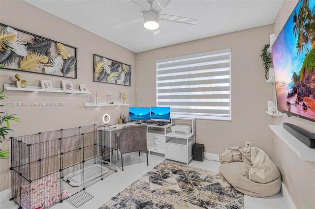 office area featuring baseboards, a ceiling fan, and a textured ceiling