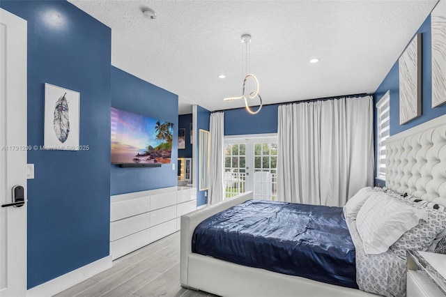 bedroom with recessed lighting, a textured ceiling, wood finished floors, and a chandelier