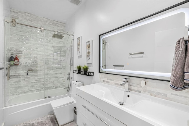 bathroom featuring backsplash, toilet, enclosed tub / shower combo, and vanity
