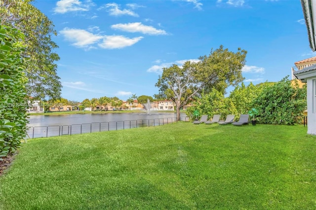 view of yard featuring fence and a water view