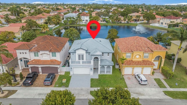 drone / aerial view featuring a water view and a residential view