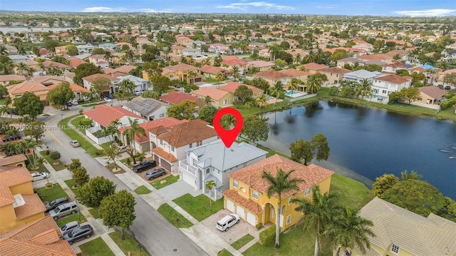 drone / aerial view with a water view and a residential view