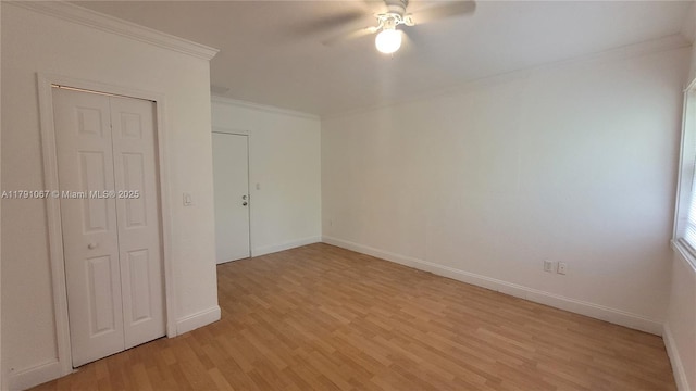 unfurnished room featuring ceiling fan, light wood-type flooring, crown molding, and baseboards