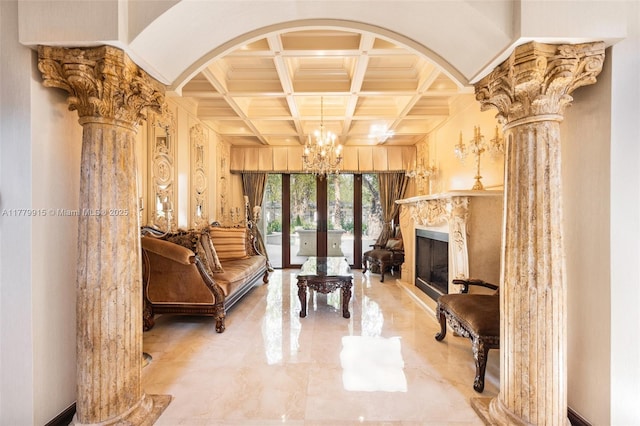 living room featuring coffered ceiling, arched walkways, an inviting chandelier, ornate columns, and marble finish floor