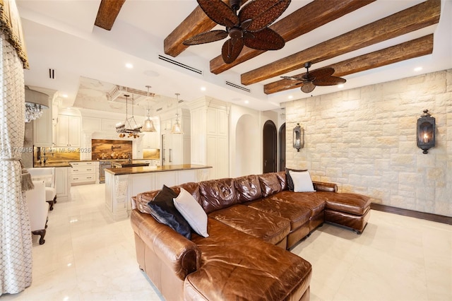 living area featuring beamed ceiling, ceiling fan, visible vents, arched walkways, and recessed lighting
