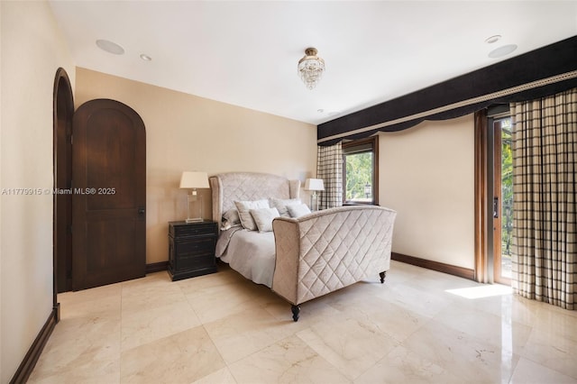 bedroom featuring baseboards and access to exterior
