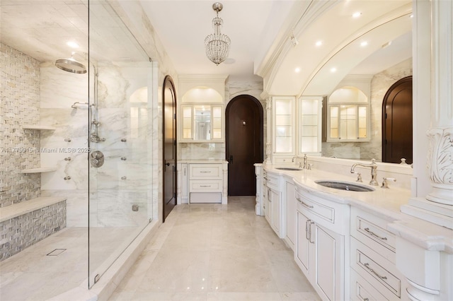 bathroom featuring double vanity, an enclosed shower, and a sink