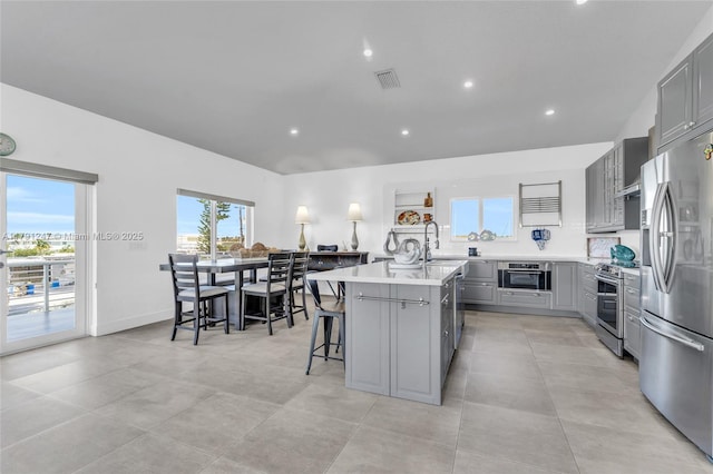 16 N Channel Dr, Key Largo, FL 33037 - kitchen with gray cabinetry, stainless steel appliances, light countertops, a center island with sink, and recessed lighting