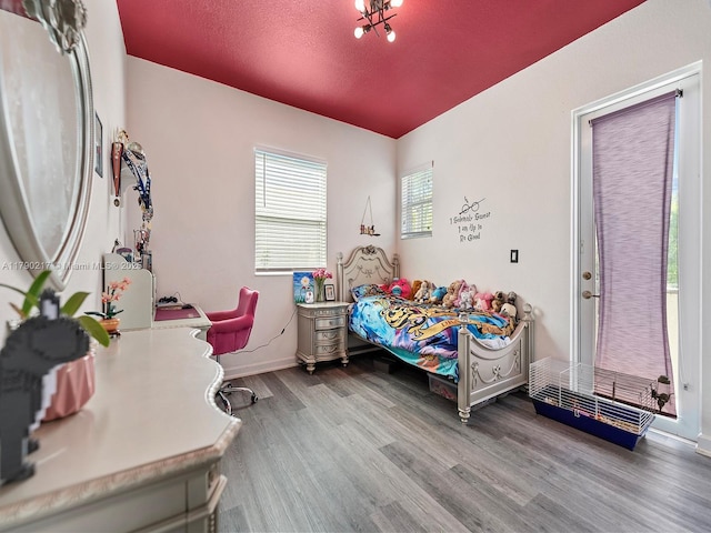 bedroom with baseboards and wood finished floors