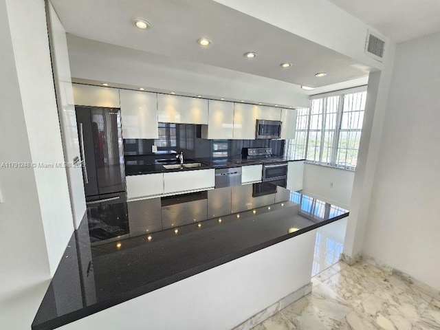 18051 Biscayne Blvd Unit 1704, Aventura, FL 33160 - kitchen with white cabinets, a sink, appliances with stainless steel finishes, dark countertops, and visible vents