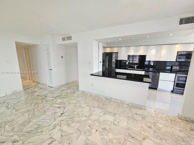 18051 Biscayne Blvd Unit 1704, Aventura, FL 33160 - kitchen with appliances with stainless steel finishes, white cabinets, dark countertops, a sink, and visible vents