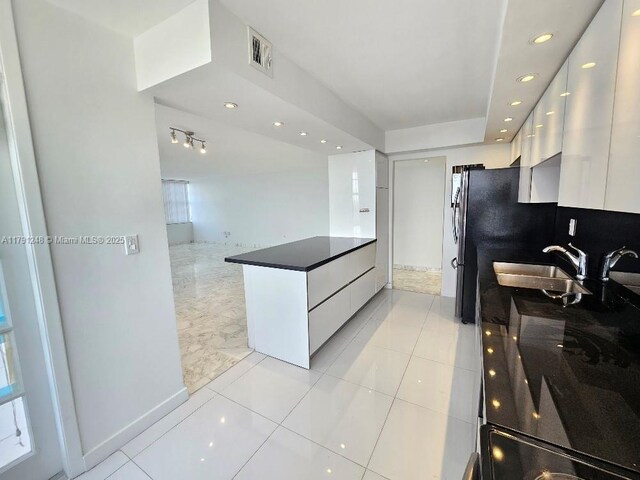 18051 Biscayne Blvd Unit 1704, Aventura, FL 33160 - kitchen with white cabinetry, dark countertops, modern cabinets, and a sink