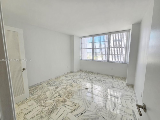 18051 Biscayne Blvd Unit 1704, Aventura, FL 33160 - unfurnished room with marble finish floor and baseboards