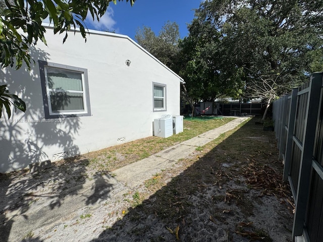 1855 NW 93rd St, Miami, FL 33147 - view of home's exterior featuring stucco siding and fence