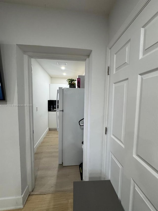 1855 NW 93rd St, Miami, FL 33147 - corridor featuring visible vents, light wood-style flooring, and baseboards