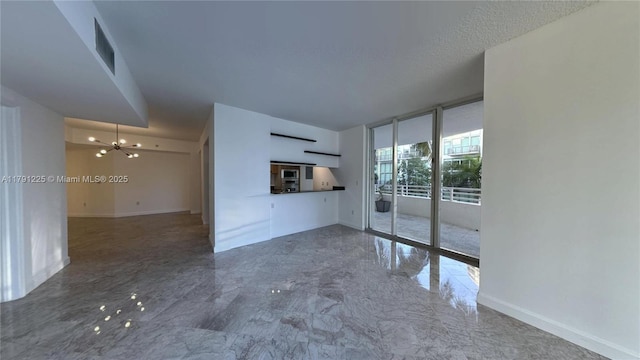 unfurnished living room featuring an inviting chandelier, marble finish floor, visible vents, baseboards, and floor to ceiling windows