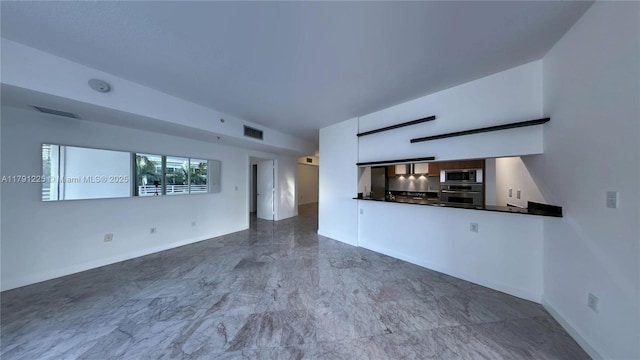 unfurnished living room featuring marble finish floor, visible vents, and baseboards