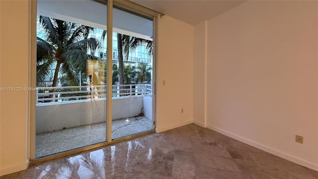spare room with baseboards