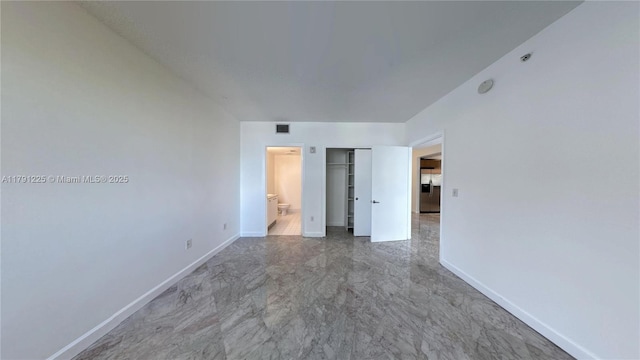 spare room featuring visible vents and baseboards
