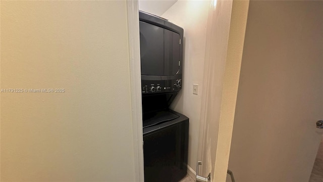 washroom featuring stacked washing maching and dryer and laundry area