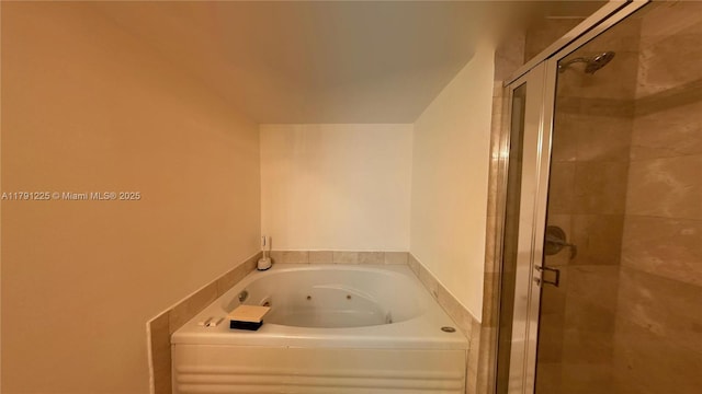 full bathroom featuring a whirlpool tub and a shower stall