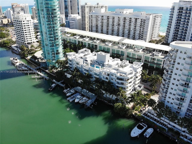 birds eye view of property featuring a view of city and a water view