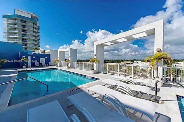 community pool with fence and a patio