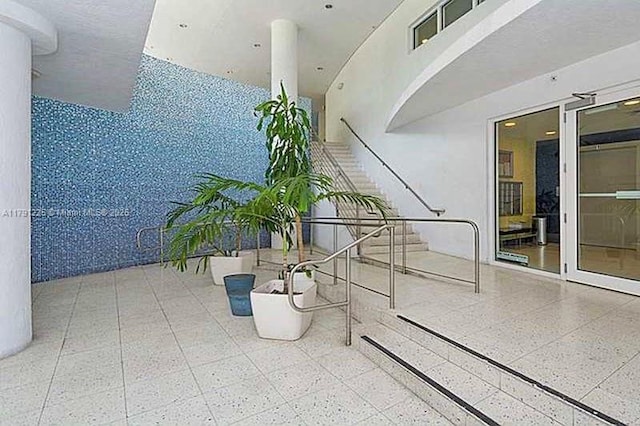 interior space with a towering ceiling and stairs