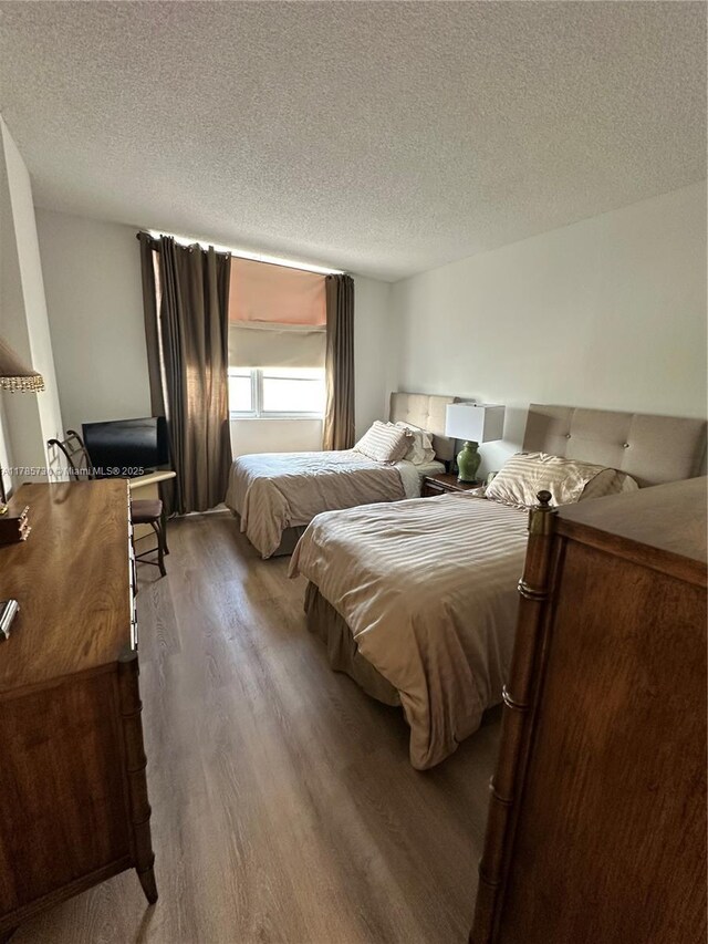 300 Bayview Dr Unit 315, Sunny Isles Beach, FL 33160 - bedroom with wood finished floors and a textured ceiling