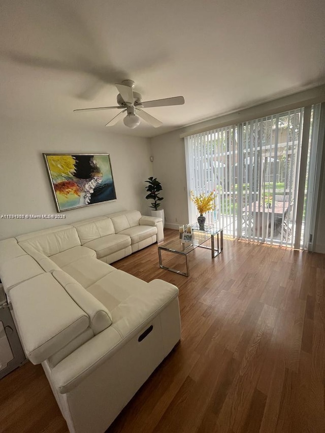 living room with wood finished floors and ceiling fan