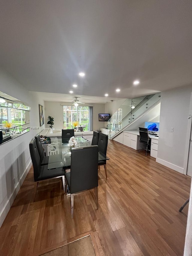 living area featuring wood finished floors, ceiling fan, recessed lighting, and built in study area