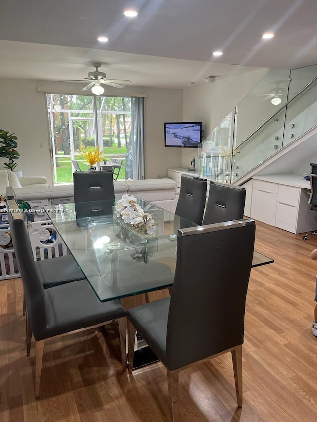 dining space with a ceiling fan and light wood-type flooring