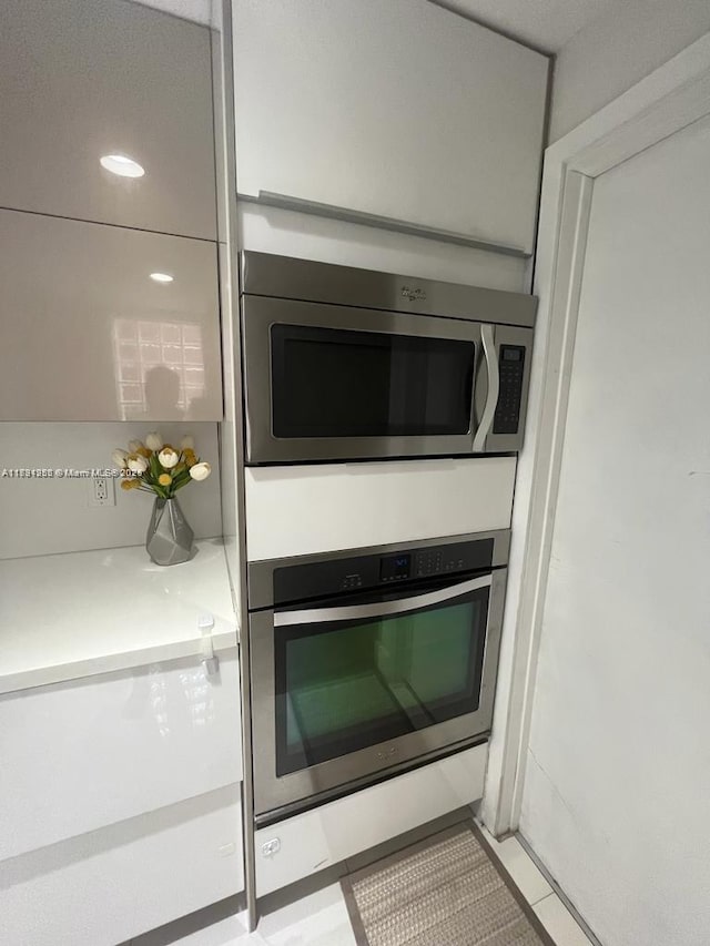 interior details featuring appliances with stainless steel finishes and light countertops