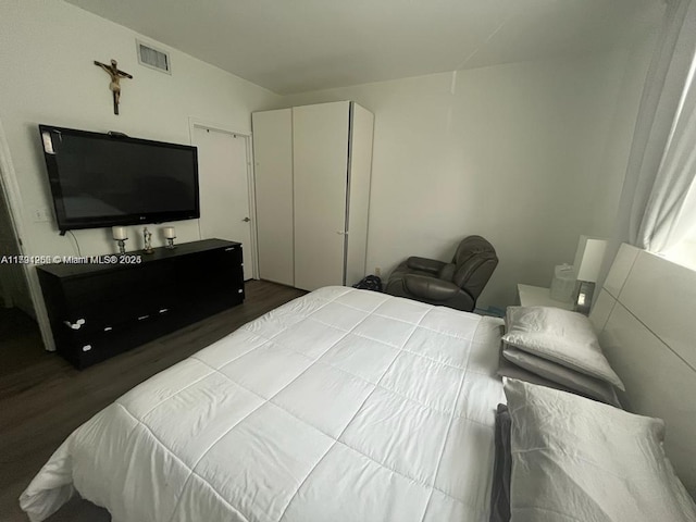 bedroom featuring visible vents and wood finished floors