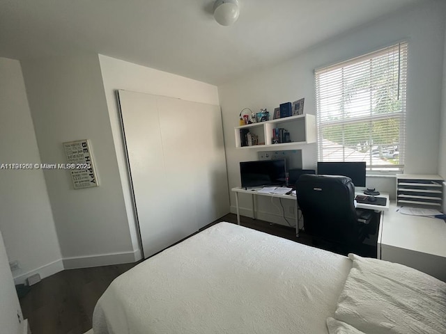 bedroom featuring dark wood-style floors and baseboards