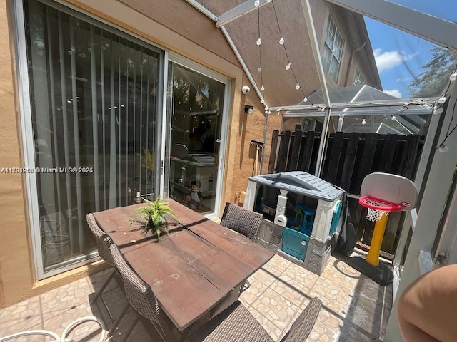 view of patio / terrace featuring fence and outdoor dining area